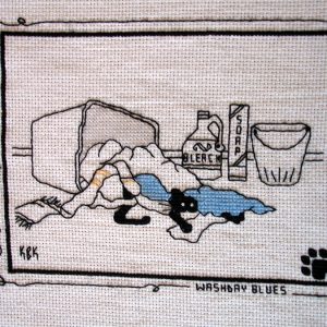 Cross Stitch Embroidery picture showing a cat and text saying "Washbay Blues" for framing