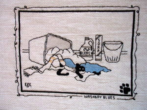 Cross Stitch Embroidery picture showing a cat and text saying "Washbay Blues" for framing